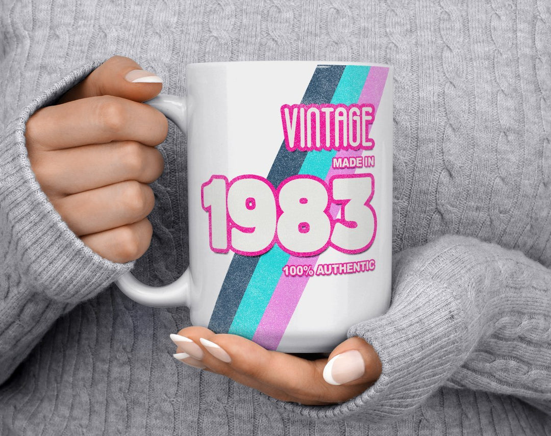 Custom Birth Year 1980's Retro Coffee Mug being held my person in grey sweater