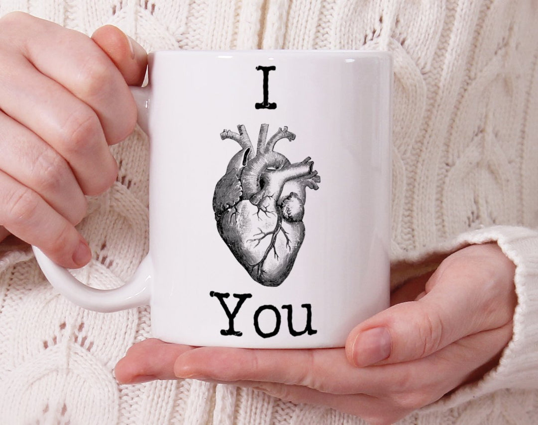 Mug that says I Heart You, and the heart is a picture of a human heart being held by person